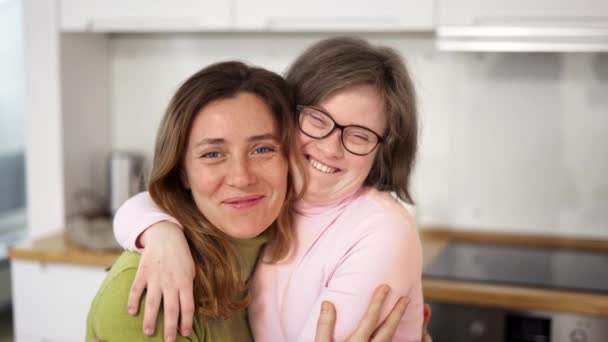 Sweet down syndrome daughter smiling with her mom — Vídeo de stock