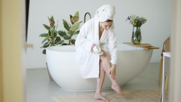 Beautiful Young Woman Applying Cream Her Legs Bathroom — Stock Video
