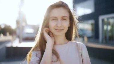 Portrait of gentle female person looking at camera with love.