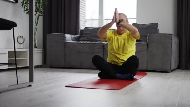 Serious Young Man Meditating Home Moving Hands Namaste Yoga Mat — Vídeo de Stock