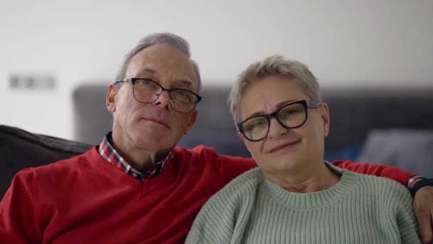 Portrait Smiling Senior Caucasian Couple Embracing Sitting Sofa — Stock video