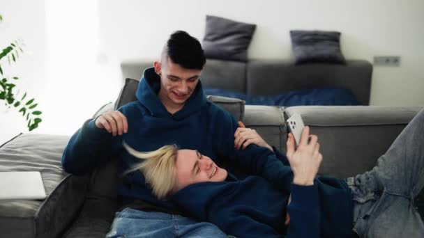 Happy Men Homosexual Couple Sit Sofa Using Smartphone Talking — Vídeo de Stock