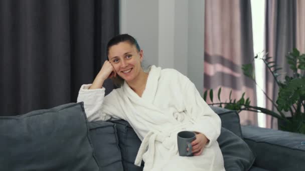 Young Woman Wearing White Bathrobe Sitting Sofa Cup Tea — 图库视频影像