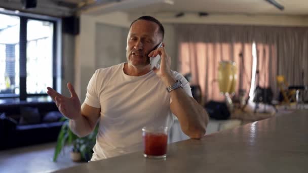 Adult Man Glasses Speaks Phone Takes Sip Red Cocktail — 图库视频影像