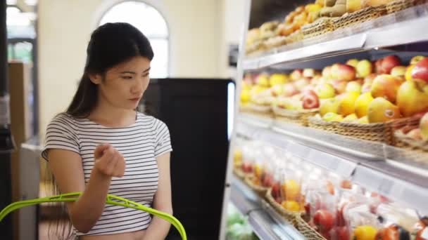 Asian Shop Visitor Chooses Fruits Vegetables Special Packages Hold Basket — Wideo stockowe