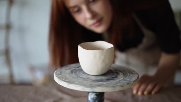 Red Haired Girl Potter Checks Her Work Spins Potters Wheel — Stock Video