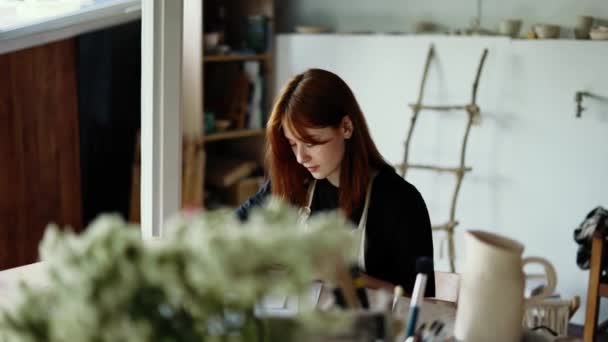 Red Haired Girl Draws Scheme Her Product Paper Pencil — Stock Video