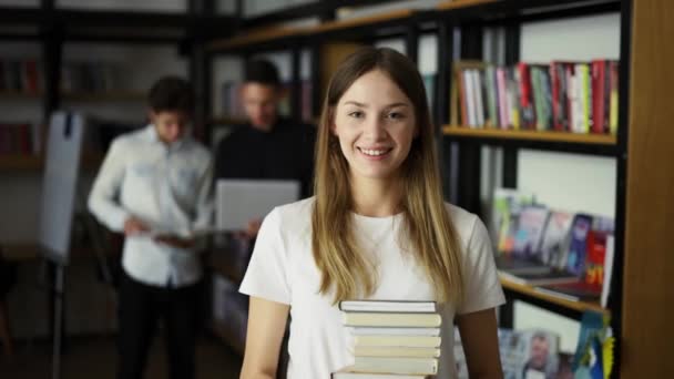 Estudante Menina Caminha Através Biblioteca Com Pilha Livros Mãos Prateleiras — Vídeo de Stock
