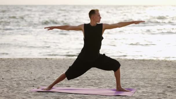 Young Man Practices Yoga While Standing Sports Mat Dawn Performing — Stock Video