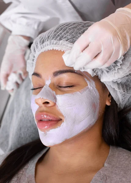 若いアフリカ系アメリカ人女性の顔に美容マスクの適用 顔の皮膚の若返りのための手順 ウェルネスリラクゼーションコンセプト — ストック写真