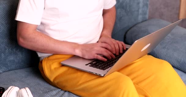 Mid Section Young Man Sitting Sofa Typing Laptop Computer — Stockvideo