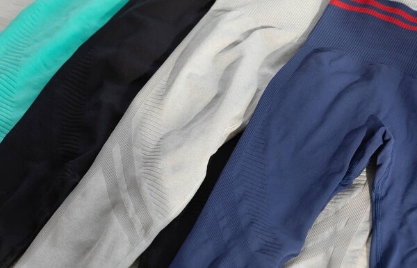 top view of colourful sports leggings on grey background