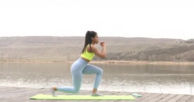 Spor yapan siyahi kadın bacak ve kalça egzersizleri yapıyor. Kas egzersizi, açık havada..