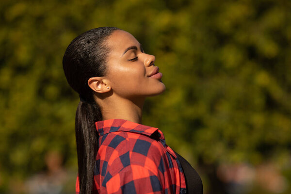 Portrait of beautiful young black woman smiling. Summer outdoor portrait of beautiful African American young woman. 