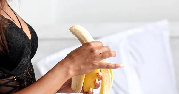 Cropped Shot Young Woman Underwear Eating Banana Bedroom — Stockfoto