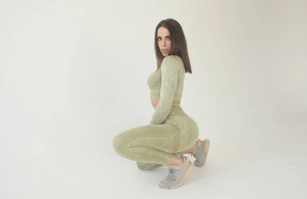 Beautiful Young Woman Dressed Green Sports Uniform Posing Studio Grey — стоковое фото