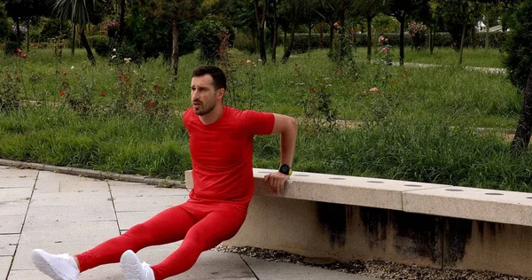 young man stretching outdoors on a summer day