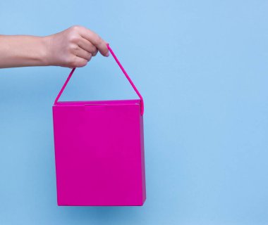 hediye paketinde mavi üzerine beyaz izole kurdele ile tutan eller