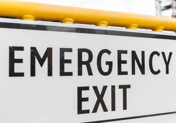 Emergency exit sign on a street with constraction. Street photo, close up, nobody, selective focus