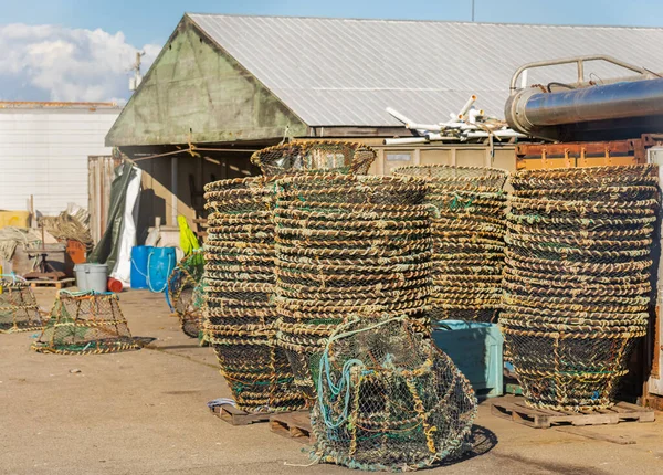 Fish trap for lobster and crab fishing. Close up of baskets used for catching and fishing shrimp, piled on a side of fishing house. Street view, travel photo, selective focus.