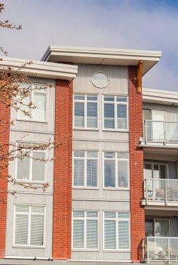 BC, Kanada 'da güneşli bir günde yepyeni bir apartman. Modern apartman binasının mimari detayları