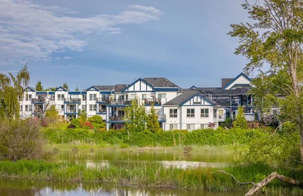 Waterfront houses exterior. Waterfront real estate in Delta BC Canada. Houses along the shore of a Fraser River-May 29,2022. Selective focus, travel photo, nobody