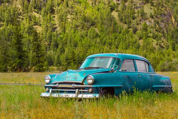 Abandoned rustic car on the hill in summer park in Canada. Vintage old car in the field. Nobody, selective focus, travel photo-June 6,2022-Princenton British Columbia