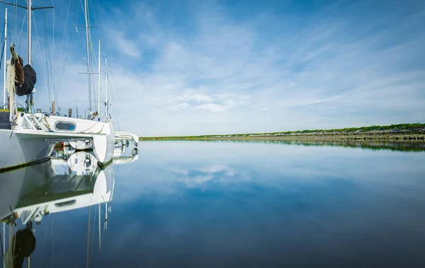 Beautiful seascape and sailing catamaran in the blue sky at the background. Sailing on Trimaran Sail Boat. Travel photo, nobody, copy space for text, summer activity and water sports activity concept