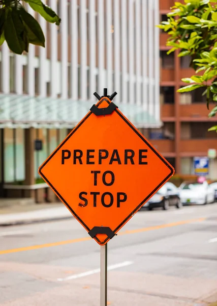 A road construction sign warns oncoming traffic and motorists. Prepare to Stop Sign. A construction sign warns motorists to prepare to stop. Nobody, street photo, selective focus