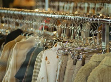 Fashionable clothes in a boutique store. Shopping. Women's stylish casual clothing in store at display window. Nobody, street photo