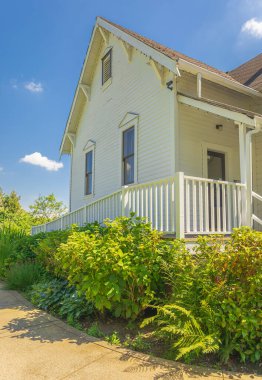 Entrance to a home through a beautiful garden with green lawn and flowers. Plants and flowers leading to entrance of a house. Front of a house with Garden design. Nobody, street photo