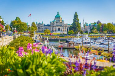 Victoria, British Columbia, Canada. Victoria Harbour and Parliament Buildings at sunny summer day. Inner Harbour, Popular tourist destination with eco-tours, unique shops, street food-July 19,2022 clipart