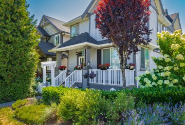 Luxury house in Vancouver, Canada. Big luxury house with a patio on sunny summer day. Selective focus, nobody.