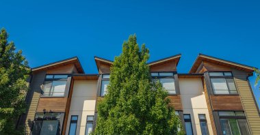 Neighborhood new modern houses building in BC, Canada. Canadian modern residential architecture. Nobody, street photo-August 6,2022-Vancouver BC, Canada.