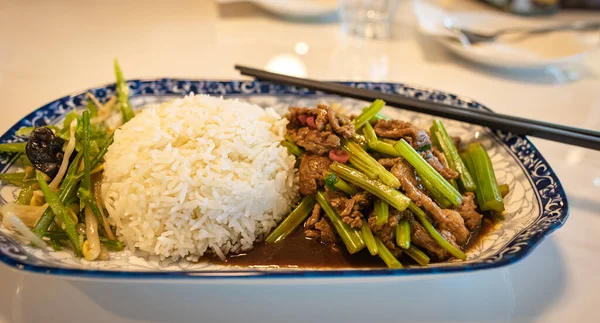 Asian food in a plate with rice. Various of asian meals at the restaurant , top view , place for text. Asian food concept. nobody.