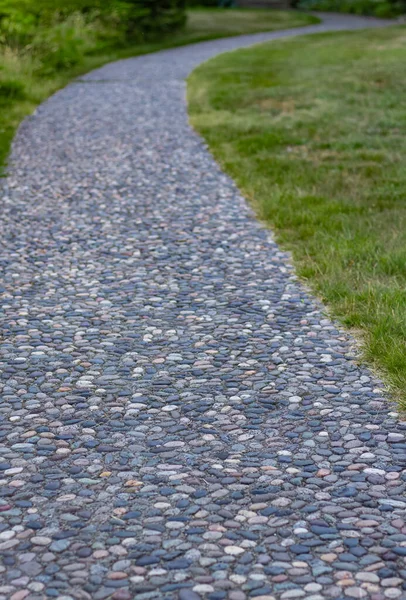 Massage stone walkway texture. A Textured Cobble Pavement, Reflexology. Pebble stones on the pavement for foot reflexology. The pebble stone floors. Nobody, copy space for text