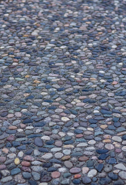Massage stone walkway texture. A Textured Cobble Pavement, Reflexology. Pebble stones on the pavement for foot reflexology. The pebble stone floors. Nobody, copy space for text