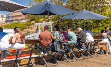 People are eating outdoors on sunny summer day. Tourists Having Lunch At street restaurant. Travel photo, selective focus-July 19,2022-Canada