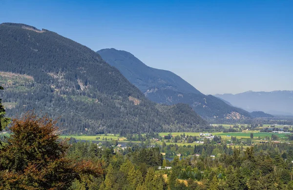 View of the Fraser Valley near Abbotsford BC. Summer in the Fraser Valley. Canadian homestead. Rural agricultural land. The Frazier River is an important salmon habitat for the lower mainland of BC