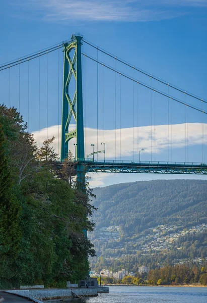 Lions Gate Bridge in summer day, Vancouver, BC, Canada. View of Lions Gate Bridge from Stanley Park. Built in the 1930s, Vancouver\'s Lions Gate Bridge spans across Burrard Inlet to the Northshore