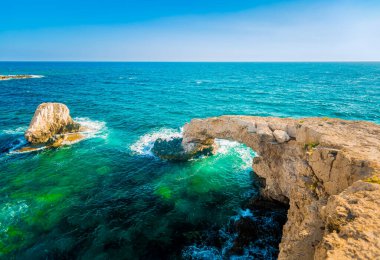 CYPRUS, Natural rocky bridge known as the Bridge of Love at Cape Greco, close to Ayia Napa town. Natural stone arch Love Bridge in Agia Napa