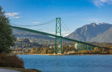 Lions Gate Bridge in summer day, Vancouver, BC, Canada. View of Lions Gate Bridge from Stanley Park. Built in the 1930s, Vancouver's Lions Gate Bridge spans across Burrard Inlet to the Northshore