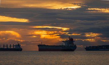 Beautiful sunset at Ferguson Point in Sanley Park Vancouver Canada. Some Anchored Cargo Ships are Visible in the Background. Harbourfont sunset with warm lights. Nobody, travel photo-September 3,2022