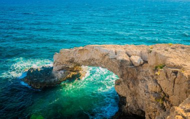 CYPRUS, Natural rocky bridge known as the Bridge of Love at Cape Greco, close to Ayia Napa town. Natural stone arch Love Bridge in Agia Napa