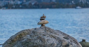 Expertly balanced stones on a Vancouver shoreline at sunset. Nobody, copy space for text, travel photo, concept photo relaxation and meditation