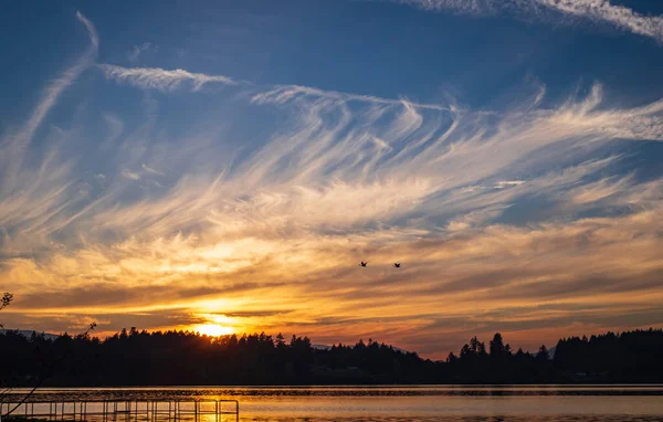 Sunset on the lake in beautiful British Columbia. Sunset at coast of the lake. Nature landscape in Canada. Nobody, copy space for text, selective focus