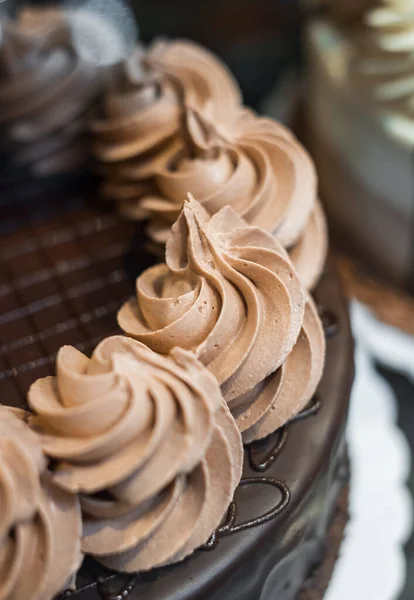 Chocolate caramel cake. Chocolate Cake with Chocolate Fudge Drizzled Icing and Chocolate Curls. Blurred, selective focus, nobody