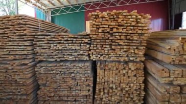 Wood warehouse. Sliced wooden boards are stored in a trading warehouse. Goods and materials arranged on a rack in warehouse.