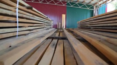Wood warehouse. Sliced wooden boards are stored in a trading warehouse. Goods and materials arranged on a rack in warehouse.