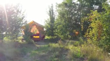 MOGYLIVKA, UKRAINE - AUGUST 21, 2022: Budget glamping for family outdoor recreation. Glamping terrace in the forest. Glamping site in the woods on a calm afternoon.